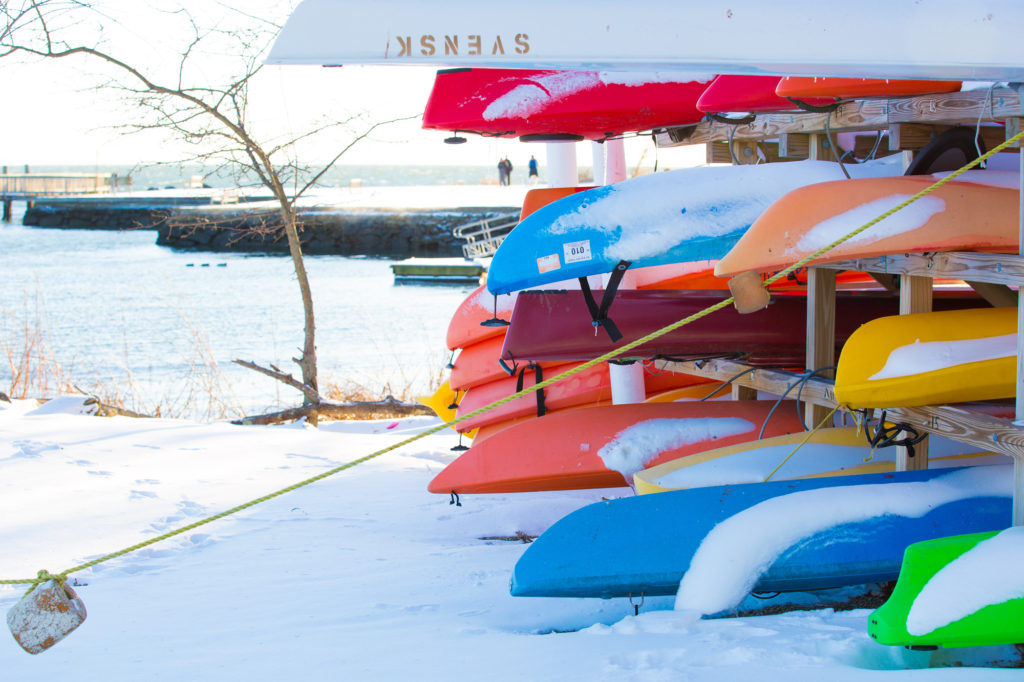 Kayaks covered in snow in Southport Connecticut at Ye Old Yacht Yard